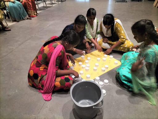 students playing cup game